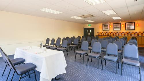 a conference room with a table and chairs at Heartland Hotel Auckland Airport in Auckland
