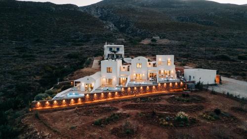 an aerial view of a large white house with lights at Makrikythera Luxury Suites - Private Pool or Hot Tub Suites in Dhiakofti
