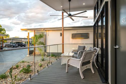 a balcony with wicker chairs and a table on a house at Athena Studio Units in Roma