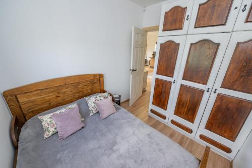 a bedroom with a wooden bed with two pillows at Poilsio oazė in Panevėžys