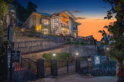 a house sitting on top of a set of stairs at The Horizon Villa Dharamshala in Dharmsala