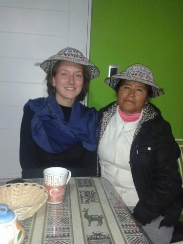 two women sitting at a table wearing hats at Arum Qurpawasi Hospedaje in Cabanaconde