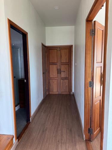 an empty room with a hallway with wooden doors at Pai Chao Kha in Pai