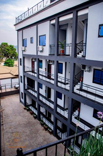 an external view of a building with balconies at Royal Hillside Apartments and Hotels in Yaoundé
