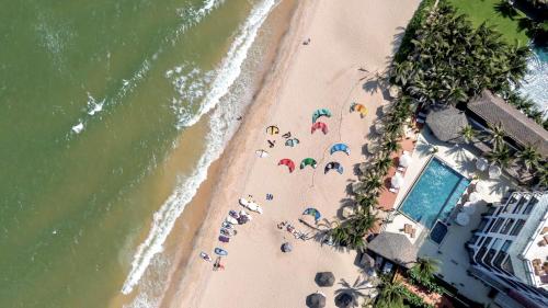 an overhead view of a beach with people with umbrellas at Mana Mui Ne Beach Resort & Spa in Mui Ne