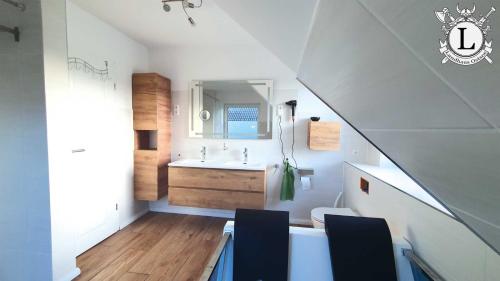 a white bathroom with a sink and a toilet at Landhaus Ferien Ostsee in Sterup