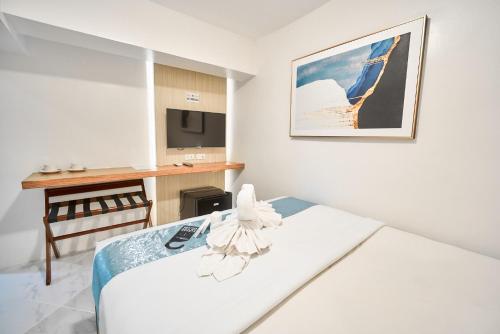 a hotel room with a bed and a desk at Circuit Hostel in Manila