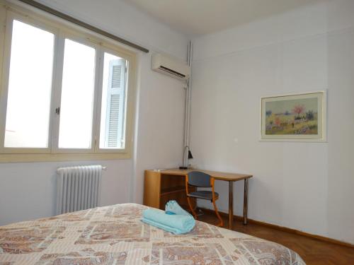 a bedroom with a bed and a desk and a table at Exarchia - Room in shared apartment in Athens