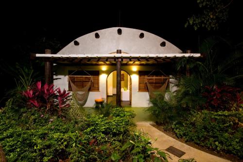 a small house with a round building with lights at Villas Sur Mer in Negril