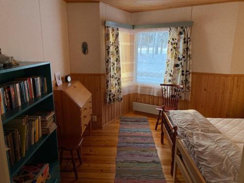 a bedroom with a bed and a window and a desk at Vuonamo - Summer cottage in Keitele