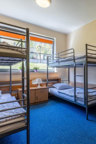 a room with three bunk beds and a window at Gdańska Szkoła Szermierki in Gdańsk
