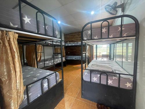 a room with three bunk beds in a room at Ha Giang Eco Bungalow in Ha Giang
