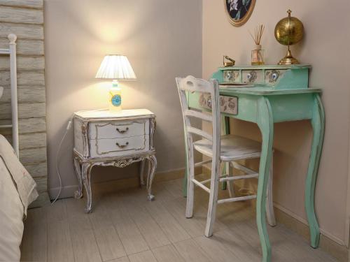 a bedroom with a desk and a chair and a lamp at Luma ospitalità in Molfetta