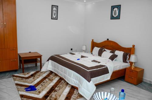 a bedroom with a large bed with a rug at Lucerna Kabgayi Hotel in Mubumbano