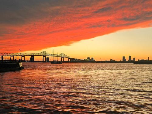 a bridge over a body of water with a sunset at 904 Nomad's Nest Mid-Century modern entertainment home with cabin vibes, 2 MEGA gamerooms, pingpong, pooltable, gym, patio in Jacksonville