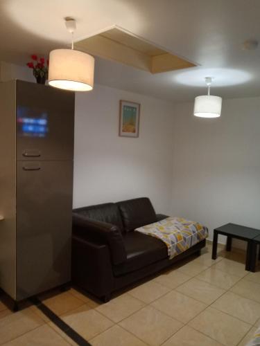 a living room with a couch and a table at Light Side Self Checkin available in Sarcelles
