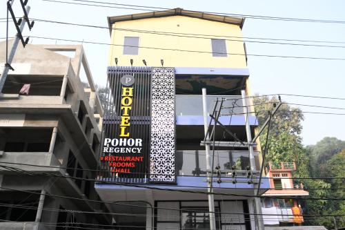 a sign on the side of a building at Hotel Pohor Regency Near Kamakhya Gate Foot Bridge in Guwahati