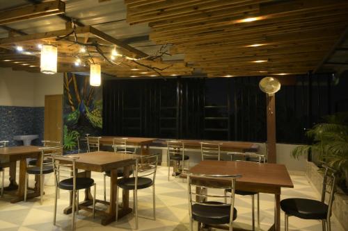 古瓦哈提Hotel Pohor Regency Near Kamakhya Gate Foot Bridge的配有木桌椅的餐厅