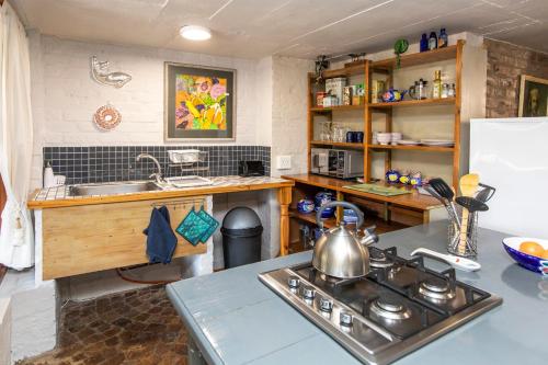 a kitchen with a sink and a stove top oven at Hennie's Rest in Malelane