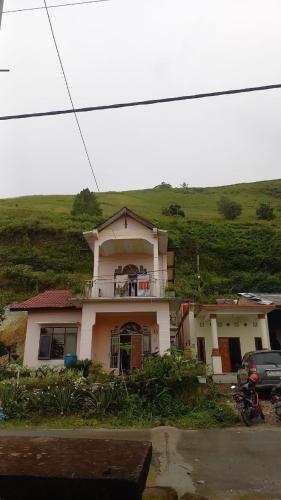a house on top of a hill with at Toba Breeze in Pangururan