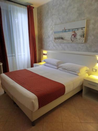 a bedroom with a large bed in a room at Hotel Lido in Varazze