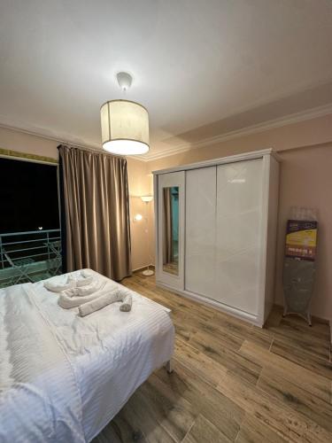 a bedroom with a white bed with towels on it at JRE-EG modern aprt11Sheikh Zayed in Sheikh Zayed