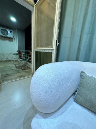 a room with a bed with a pillow and a window at JRE-EG modern aprt11Sheikh Zayed in Sheikh Zayed