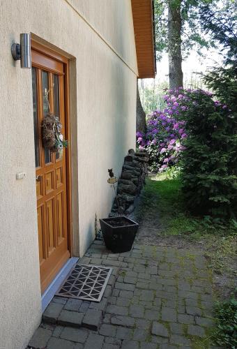 a door to a house with a garden and flowers at "Am Prerow Strom" in Prerow