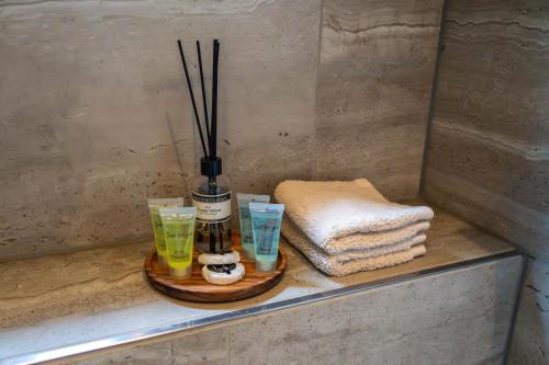 a bathroom counter with a bottle and some glasses at B&B Wellness 'De Bourgondische Lelie' in Bunschoten