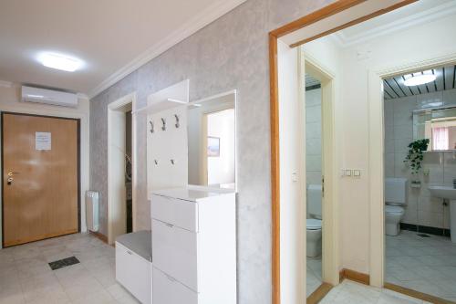 a white bathroom with a sink and a toilet at Montesan Luxury Apartments Sveti Stefan in Sveti Stefan