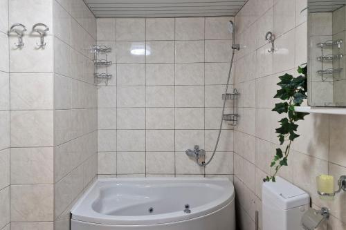 a white bathroom with a tub and a toilet at Montesan Luxury Apartments Sveti Stefan in Sveti Stefan