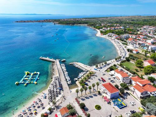 an aerial view of a beach with a marina at Hidden Oasis - pool, playground - 3 min from the beach in Vir
