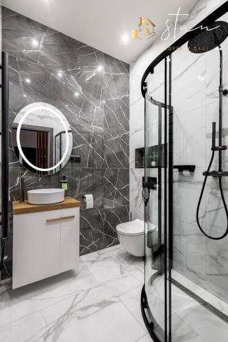 a bathroom with a shower and a toilet and a mirror at Residence S7 - Luxury living Apartment in Prešov