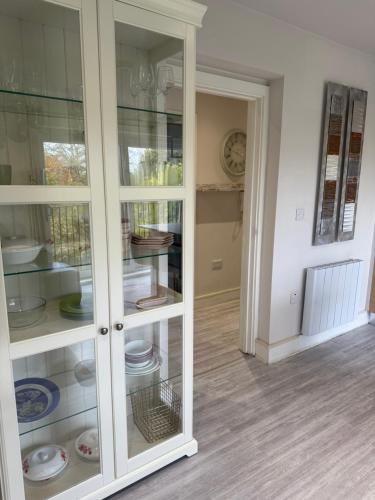 a white cabinet with glass doors in a room at Luxury Spacious Flat close to Central London in London