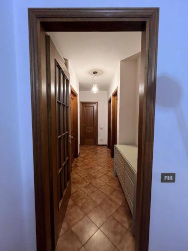 a hallway with an open door to a room at Affittacamere Vetuliae Foligno in Foligno