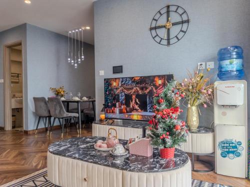 a living room with a christmas tree on a table at Vinhomes Ocean Park Gia Lam by QMP in Hanoi