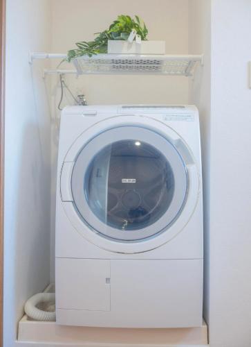 a washing machine with a plant on top of it at sun inn in Tokyo