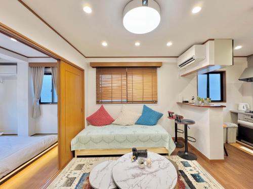 a small bedroom with a bed and a table at sun inn in Tokyo