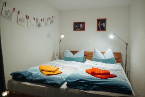 a bed with three pillows and towels on it at Ferienwohnung Czornebohblick in Kubschütz
