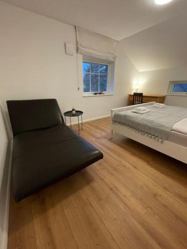 a bedroom with a bed and a window at Stilvolles Naturidyll bei Berlin in Glienicke