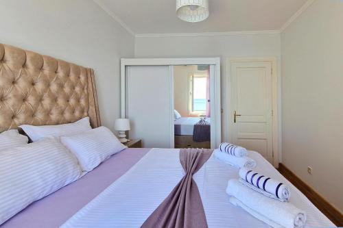 a bedroom with a large bed with two pillows on it at Montesan Luxury Apartments Sveti Stefan in Sveti Stefan