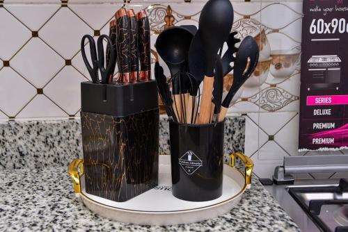 a black container filled with utensils on a counter at Barnabas Nakuru Comfy Homestays in Nakuru