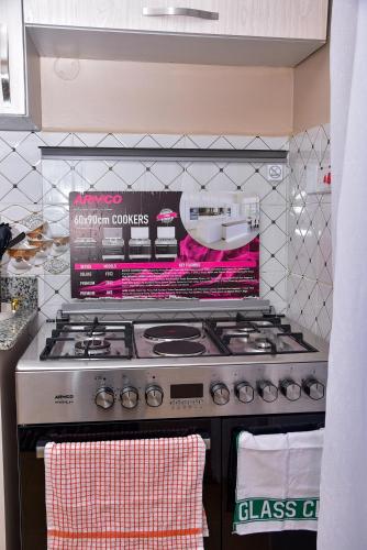 a kitchen with a stove with a box on it at Barnabas Nakuru Comfy Homestays in Nakuru