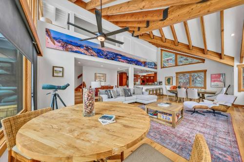 a living room with a wooden table and a ceiling at Stunning Mountain Gem with Hot Tub Near Palisades in Olympic Valley