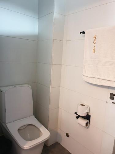 a bathroom with a white toilet and a towel at Starlight tiny home in Lotus Island