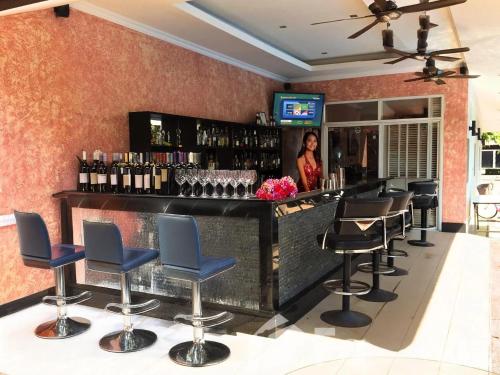 a bar with chairs and a counter with wine bottles at Luxury One Bedroom Private Pool Villa in Jomtien in Jomtien Beach