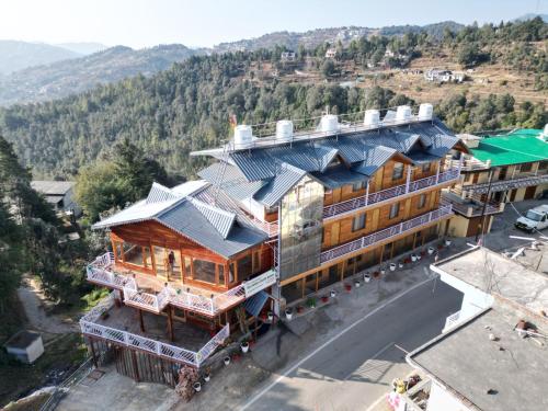 an overhead view of a building with a house at The Golden Castle Hotels in Mukteswar