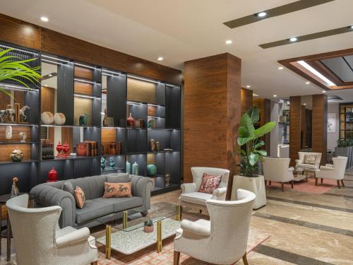 a lobby with a couch and chairs and shelves at Mercure Ankara Kızılay in Ankara