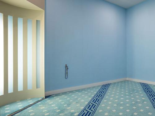 an empty room with a bed and blue walls at Mercure Ankara Kızılay in Ankara