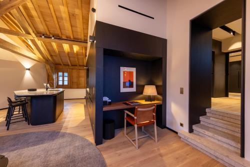 a home office with a desk in the middle of a room at Les Suites by Cave Vauban in Dijon